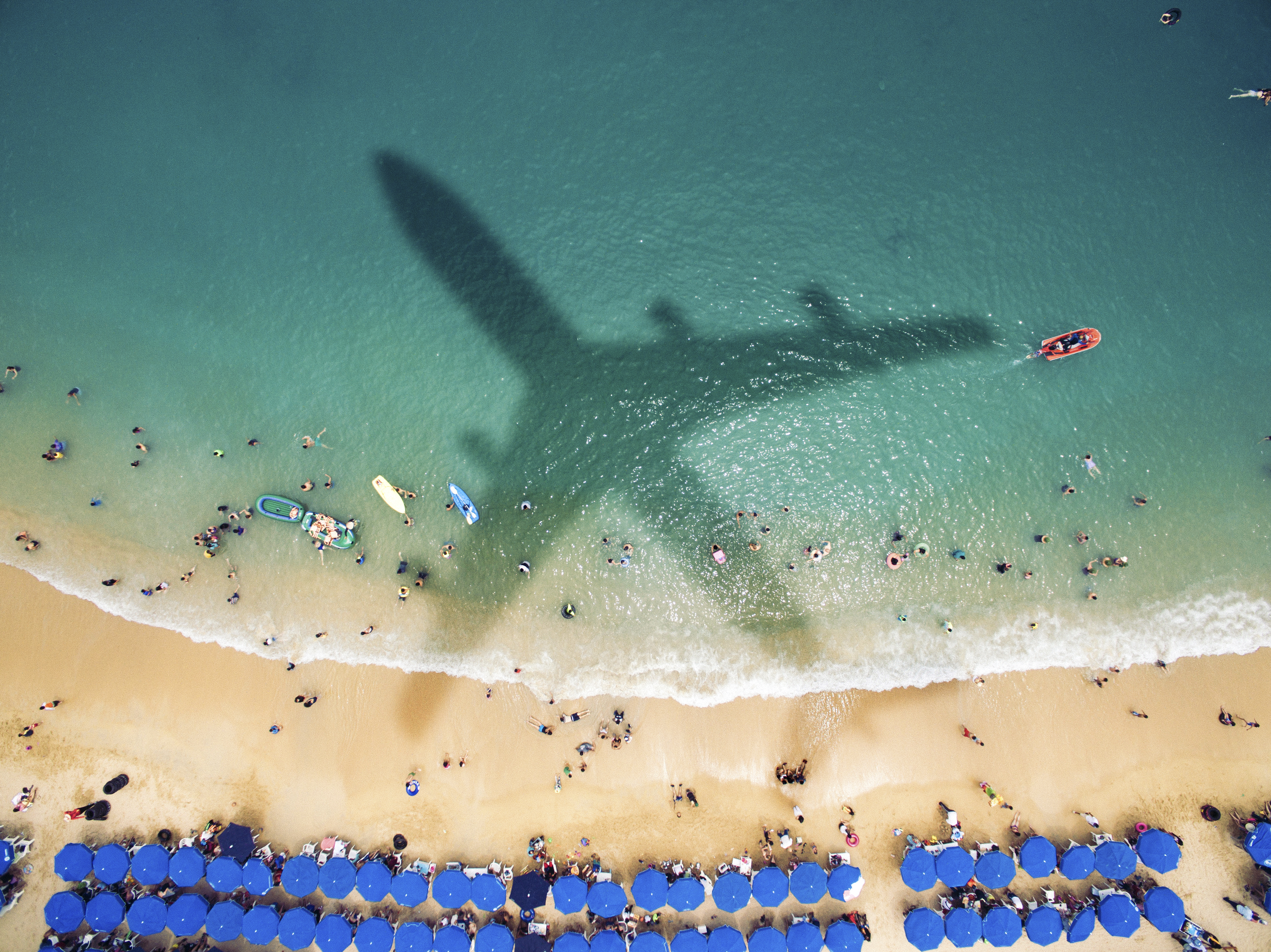 Airplane over latin american beach