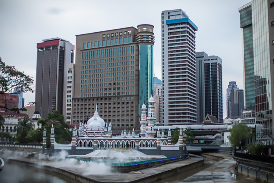 At night, the river and mosque are illuminated.